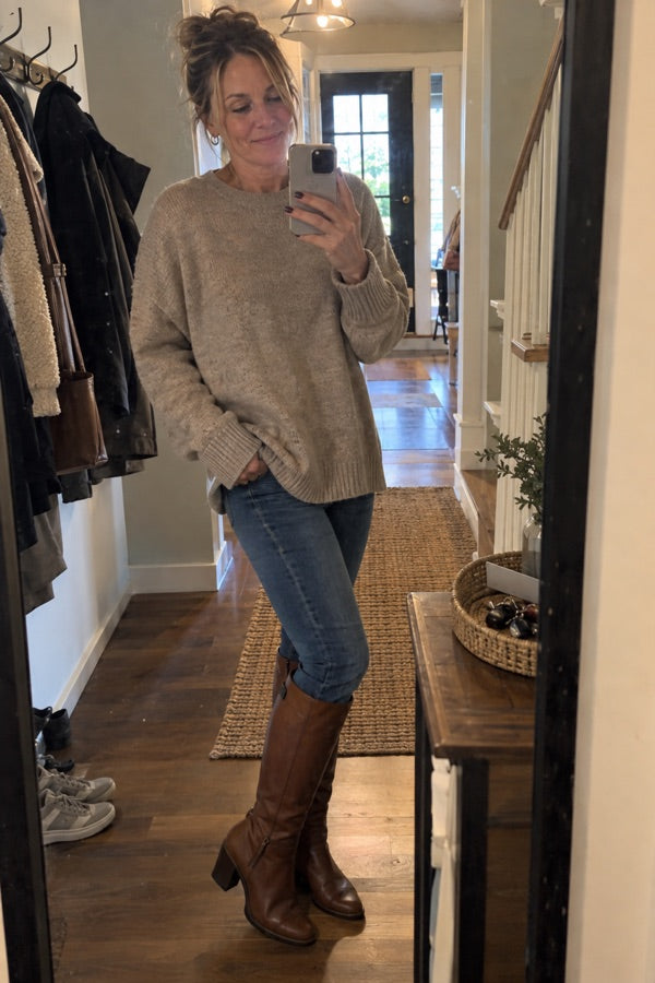 Customer mirror selfie of Jennifer Adams in tall brown leather boots